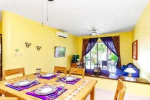 a dining room with a wooden table and chairs at Perfect Villa with Pool Access and Close to the Beach in Playa del Carmen