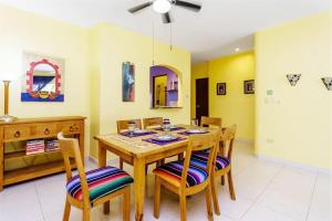 a dining room with a wooden table and chairs at Perfect Villa with Pool Access and Close to the Beach in Playa del Carmen