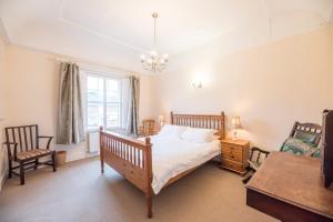 a bedroom with a bed and a table and chairs at Varley House, Saxmundham in Saxmundham