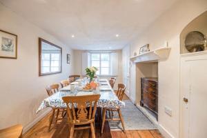 a dining room with a long table and chairs at Varley House, Saxmundham in Saxmundham