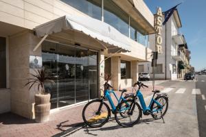 two bikes are parked outside of a building at Hotel Sina Astor in Viareggio