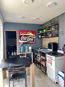 a kitchen with a coca cola sign on the wall at Minicasas La Villa in Santa Sofía