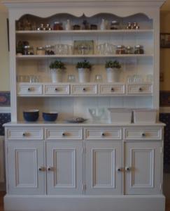 a large white hutch with dishes on it at Westwinds Guestlodge in Galway