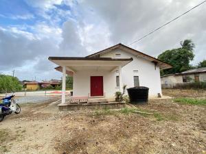 a small white house with a red door at MY Gunung Homestay Vintage in Bachok