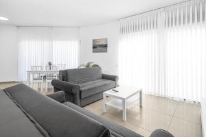 a living room with a couch and a table at Luxury Penthouse With Sea View #62 By Hashdera Eilat in Eilat