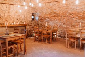 a room with wooden tables and chairs and a brick wall at Numa' Bun in Rupea +28 photos