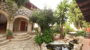 a garden with a pond in front of a building at Eski Datca Evleri in Datca