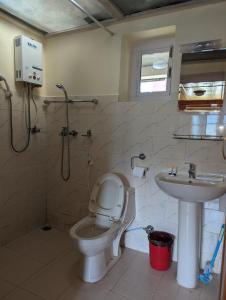 a bathroom with a toilet and a sink at Lukla Himalaya Lodge in Lukla