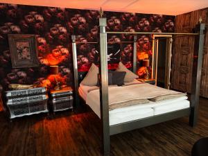 a bedroom with a bed with a wall covered inkeyes at Time Out 3 in Vreden