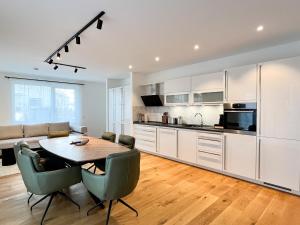 a kitchen and dining room with a table and chairs at YUVA HOMES Germering - 100m2 - nahe München - 2 Bäder - Garten&Terrasse - S-Bahn in Germering +52 photos