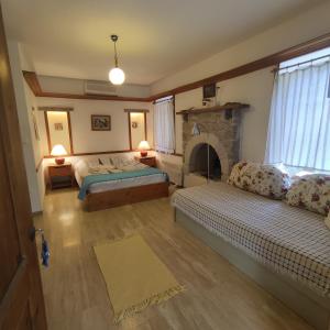 a living room with two beds and a fireplace at Eski Datca Evleri in Datca