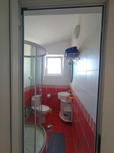 a bathroom with two toilets and a glass shower at Apartments in Bar city center in Bar +17 photos