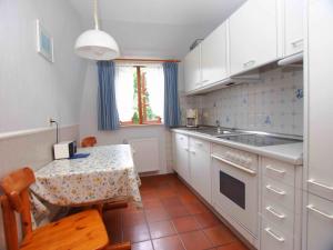 a small kitchen with a table and a sink at Gaestehaus-Bruhn-5 in Alkersum