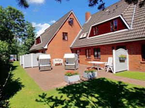 a house with a patio in front of it at Gaestehaus-Bruhn-5 in Alkersum