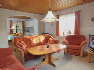 a living room with a couch and a table at Gaestehaus-Bruhn-1 in Alkersum