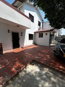 a parking lot in front of a white building at Casa Naty Crespo in Cartagena de Indias
