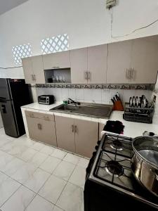 a kitchen with a stove and a counter top at Casa Naty Crespo in Cartagena de Indias +5 photos