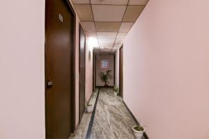 a corridor of an office with potted plants at Hotel O Manya Stay in New Delhi
