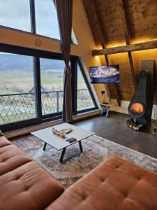 a living room with a couch and a table at Luxury Villa Mašić in Čardaci