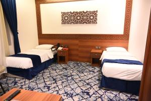 Postel nebo postele na pokoji v ubytování فندق نجمة العزيزية hotel Star AL Aziziyah