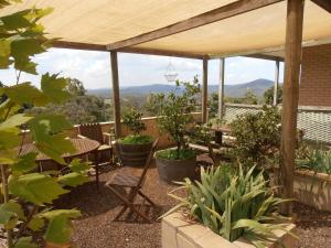 a patio with a table and chairs and mountains in the background at Springmead B&B in Rydal