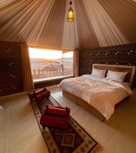 a bedroom with a bed with a view of the ocean at Sofia Valley Camp in Wadi Rum +53 photos