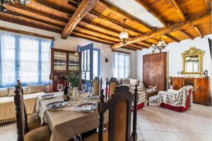 a dining room with a table and a couch at Amazing View House in Skopelos Town