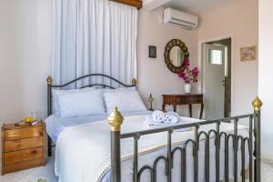 a bedroom with a bed and a mirror at Amazing View House in Skopelos Town
