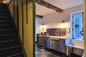 a kitchen with green and white walls and a staircase at Kinta Panda Pool Table City Center 13 2 guests in Honfleur