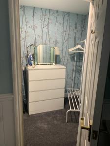 a dresser with a mirror and a dresser with a dresser at Garden flat in a quiet Camden spot in London +5 photos