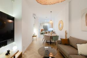 a living room with a couch and a table at Luxury central apartment in Madrid