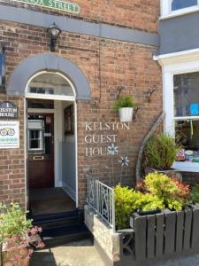 a brick building with the entrance to a kitchen guest house at Kelston Guest House in Weymouth
