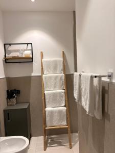 a towel ladder in a bathroom with towels at Penthouse Apartment A due passi dal Mare in Alghero +33 photos