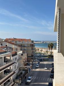 a view of a street with cars parked in a city at Penthouse Apartment A due passi dal Mare in Alghero