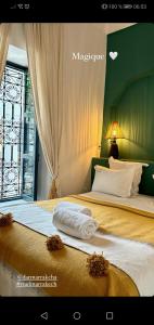 two beds in a hotel room with towels on them at Riad Dar Marrakcha in Marrakesh