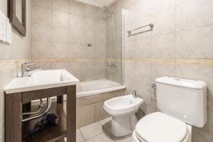 a bathroom with a toilet and a sink and a shower at Apartments Babel Recoleta in Buenos Aires +34 photos