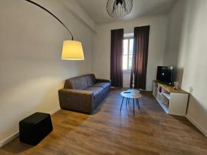 a living room with a couch and a table at Be Your Home - Stazione Mare in Civitavecchia +7 photos