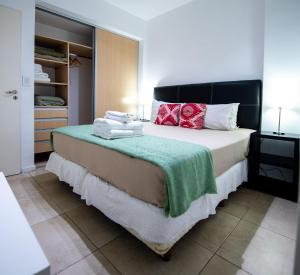 a bedroom with a bed with towels on it at Apartments Babel Recoleta in Buenos Aires