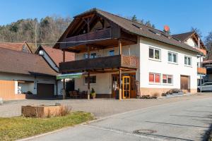 a large house with a wooden roof on a street at Obstgut Mit Herz Thomas Maier in Stockach