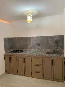 a kitchen with a counter top and a sink at Nomad Surf Lodge in Imsouane