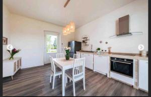 a kitchen with a table and chairs in a room at Modern trulli with a beautiful new pool in Ceglie Messapica