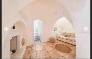a living room with a couch and a fireplace at Modern trulli with a beautiful new pool in Ceglie Messapica +37 photos