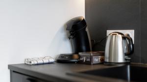 a coffeemaker sitting on a counter with a coffee maker at L'Edelweiss du Lac in Tresserves