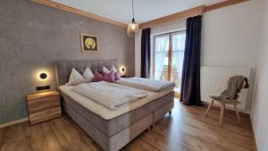 a bedroom with a large bed and a window at Gästehaus Alpenparadies in Krün