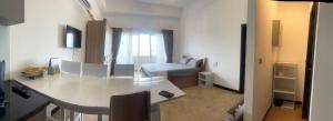 a white living room with a table and a couch at Sea view - Luxury Apartments by Tyronne in Negombo