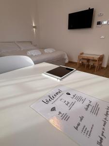 a hotel room with a bed with a tablet on it at Bergamini 23 Lake Garda in Peschiera del Garda