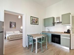 a kitchen and dining room with a table and chairs at L'altro Krisà in Bari