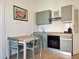 a kitchen with a table and chairs in a room at L'altro Krisà in Bari