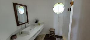 une salle de bain blanche avec un lavabo et un miroir dans l'établissement Casa em Maresias com vista pro mar, à São Sebastião 29 autres photos