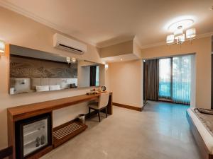 a living room with a desk and a fireplace at Ivy Sailing Resort Hotel in Ayvalık